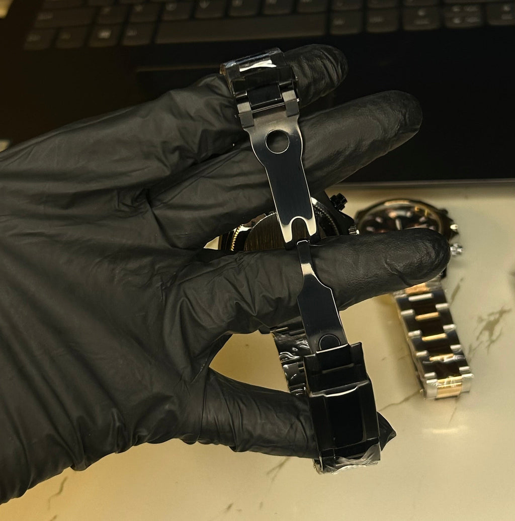 Black quartz watch with stainless steel bracelet, top view