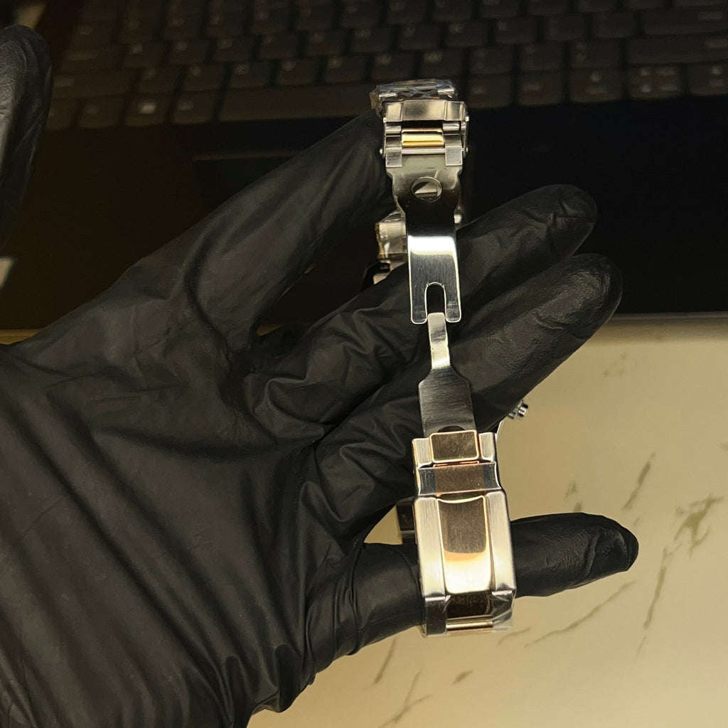 Two-tone Daytona-style watch bracelet detail