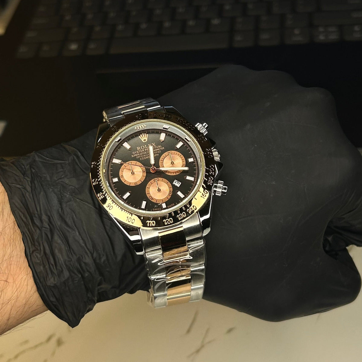 Two-tone Daytona-style watch with black dial, front view