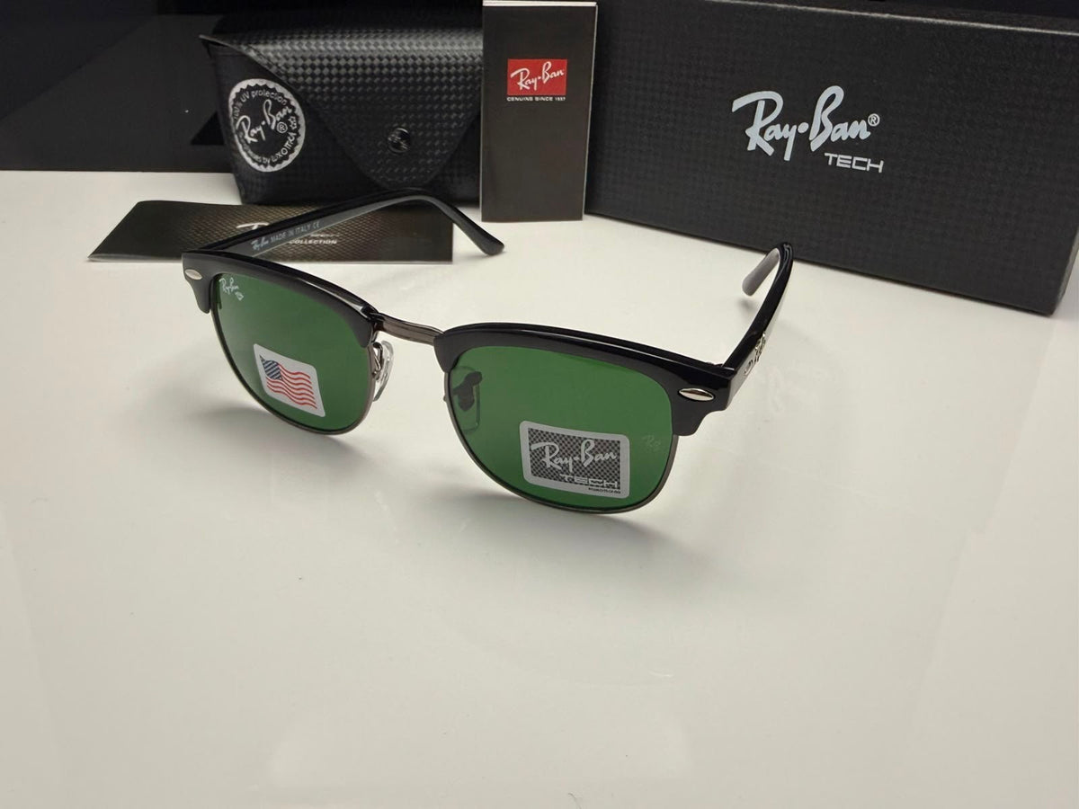 Ray-Ban Clubmaster sunglasses with green lenses and black frames, displayed with their black case, box, and card on a white surface.
