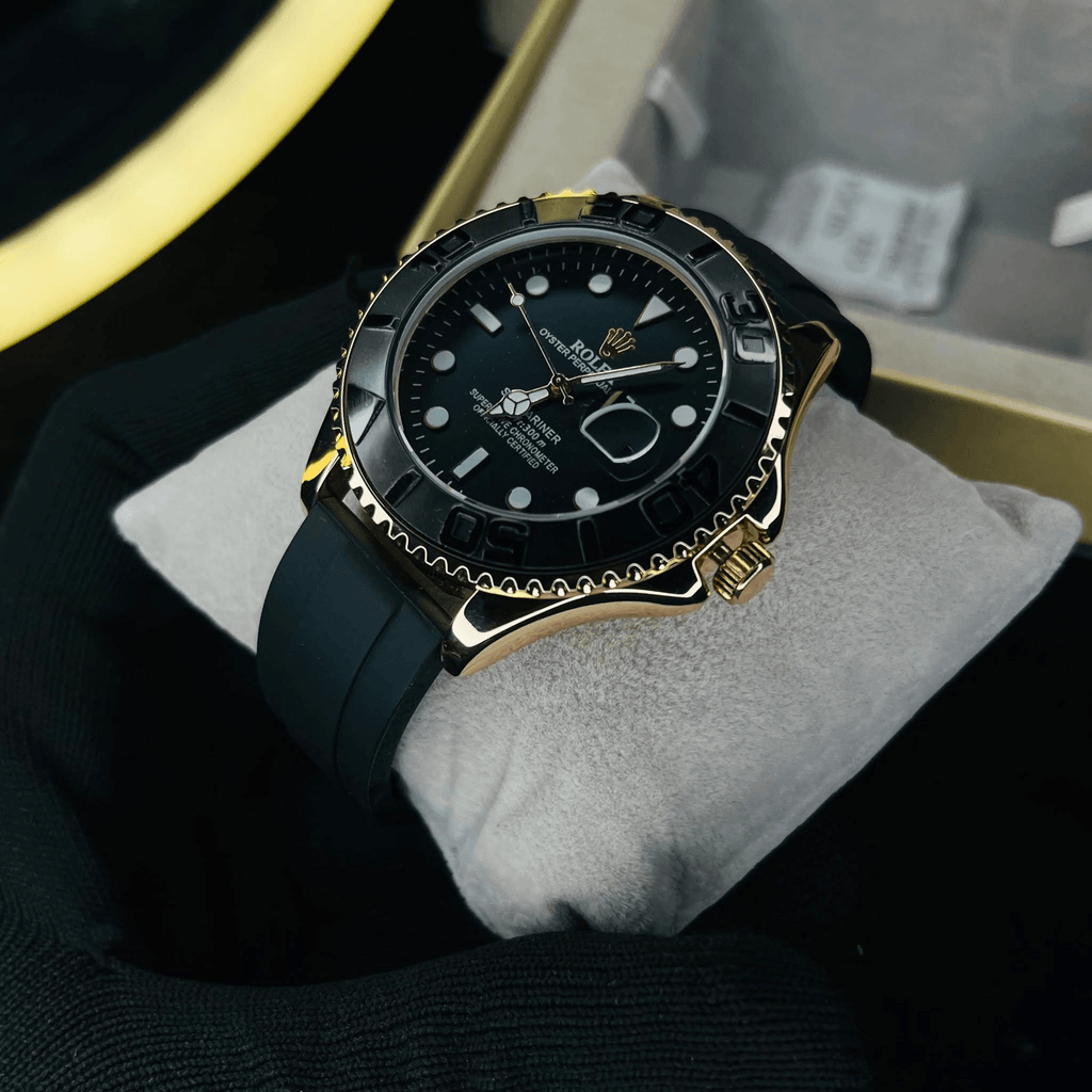 A Rolex Submariner Date watch with a black dial, black bezel, and gold-tone case, resting on a white cushion inside its box.