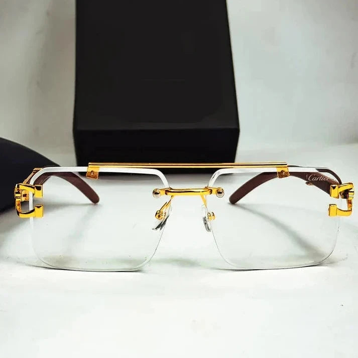 Gold-framed glasses with brown accents on a white surface